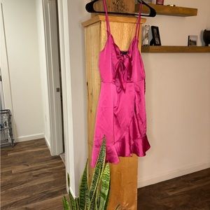 Adorable hot pink cocktail dress. Ruffle details and bow tie front. Worn once.